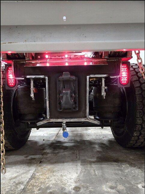 Heavy-duty pintle hook and rear suspension installation on a work truck
